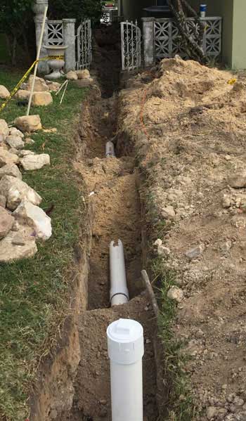 Trench with new PVC Sewer Pipe installed