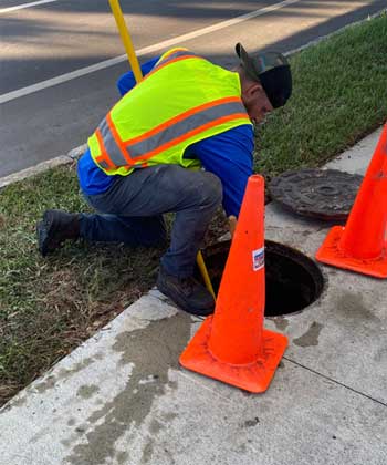 Plumber Cleaning a Drain