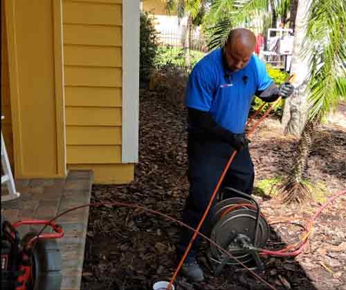 Plumber Completing a Residential Drain Cleaning