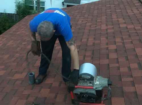 Plumber Cabling Drain From Roof Vent - St. Petersburg Drain Cleaning