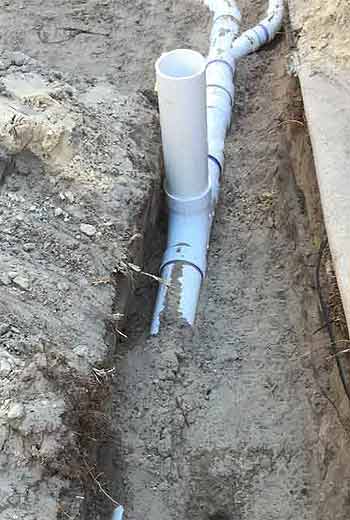 New 4 inch PVC Sewer lines in trench prior to back filling dirt