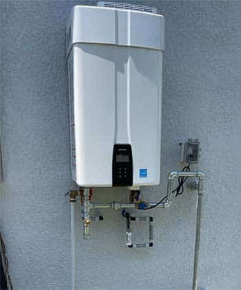 Tankless Gas Water Heater Mounted on outside wall of home