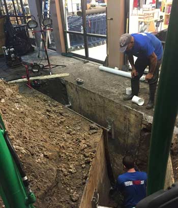 Plumbers Repairing a Commercial Sewer in a Shopping Center