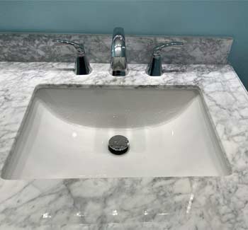 2 handle chrome lavatory faucet on marble vanity top