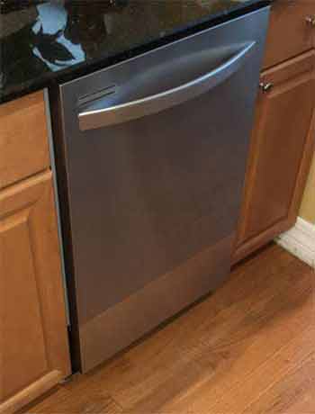 Stainless Steel Dishwasher installed under black marble kitchen counter top