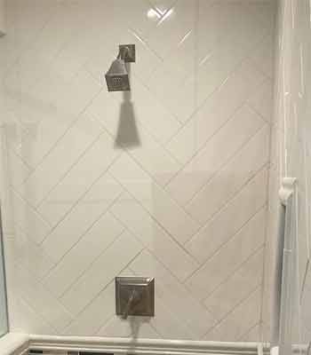 Brushed Chrome Shower Valve and Shower Head in Beige Tiled Shower Stall