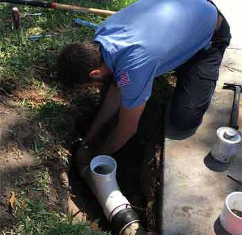 Plumber repairing 4" PVC Sewer Pipe