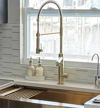 Gold Pull down kitchen faucet and gold farm sink