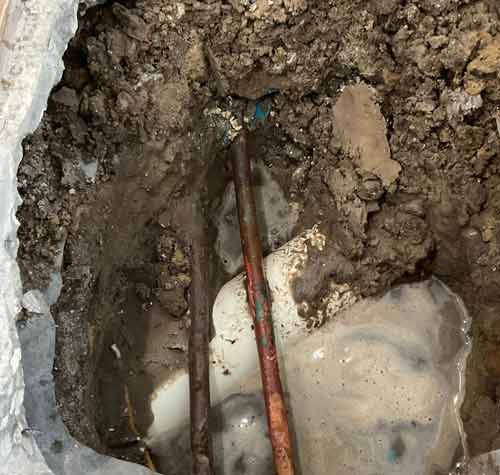 Water Pooling Under Concrete Slab of House Due to A Hidden Leak in a Copper Pipe