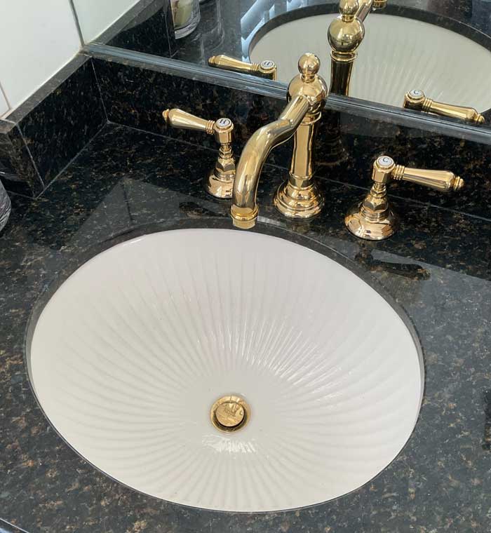 Undermount porcelain bathroom sink with gold dual handle high rise lavatory faucet