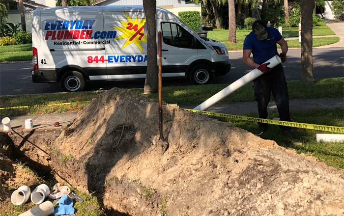 Plumber installing new Schedule 40 PVC sewer Line