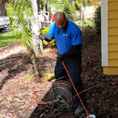 EVERYDAYPLUMBER.com plumber using drain cleaning equipment to clear a clogged drain.