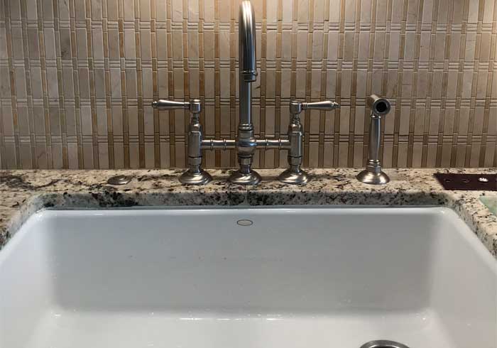 Two Handle goose neck kitchen faucet with sprayer installed in Clearwater, FL