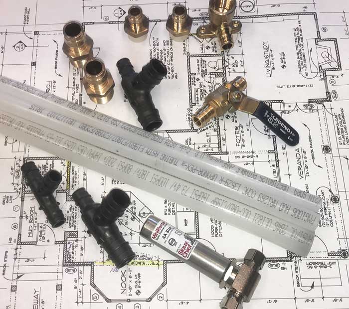 Pex-A tubing, fittings, and valves for re-piping a home laying on a blueprint for a home in Clearwater, FL