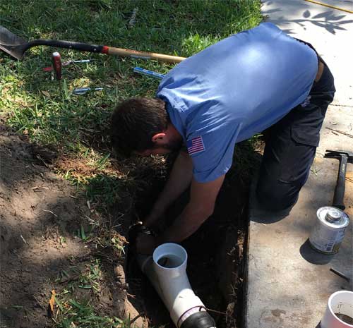 Plumber performing a sewer repair in Tampa