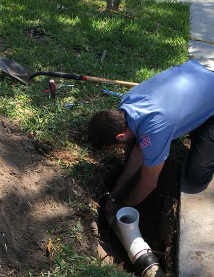 Plumber performing an emergency sewer repair in Tampa