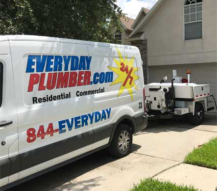 EVERYDAYPLUMBER.com plumbing van with a hydro-jetting machine in front of a residence in Tampa, FL