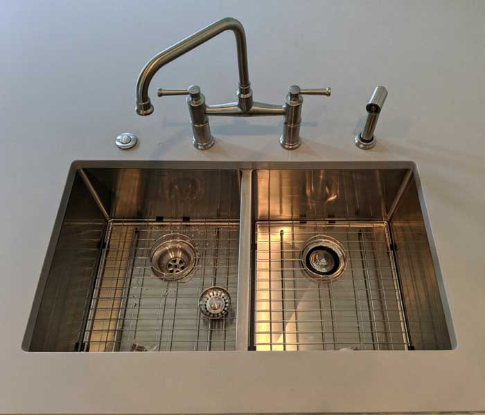Stainless steel 2 compartment sink with brushed stainless steel kitchen faucet installed in a home in Wesley Chapel, FL