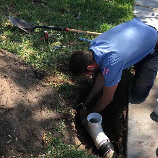 Plumber performing an emergency sewer repair