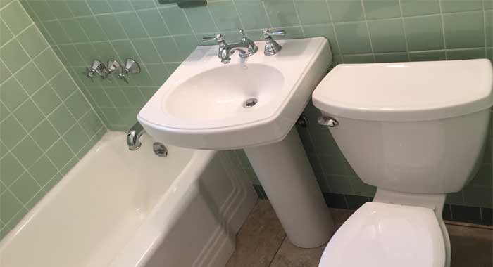white Toilet, Sink , and tub in a Land O' Lakes home