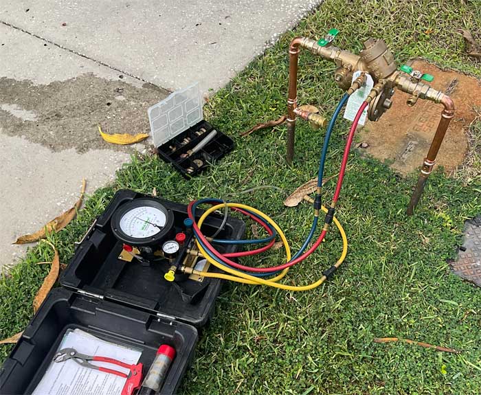 Why Should You Test Your Backflow Device? Backflow preventer testing equipment connected to a backflow device in Tampa, FL