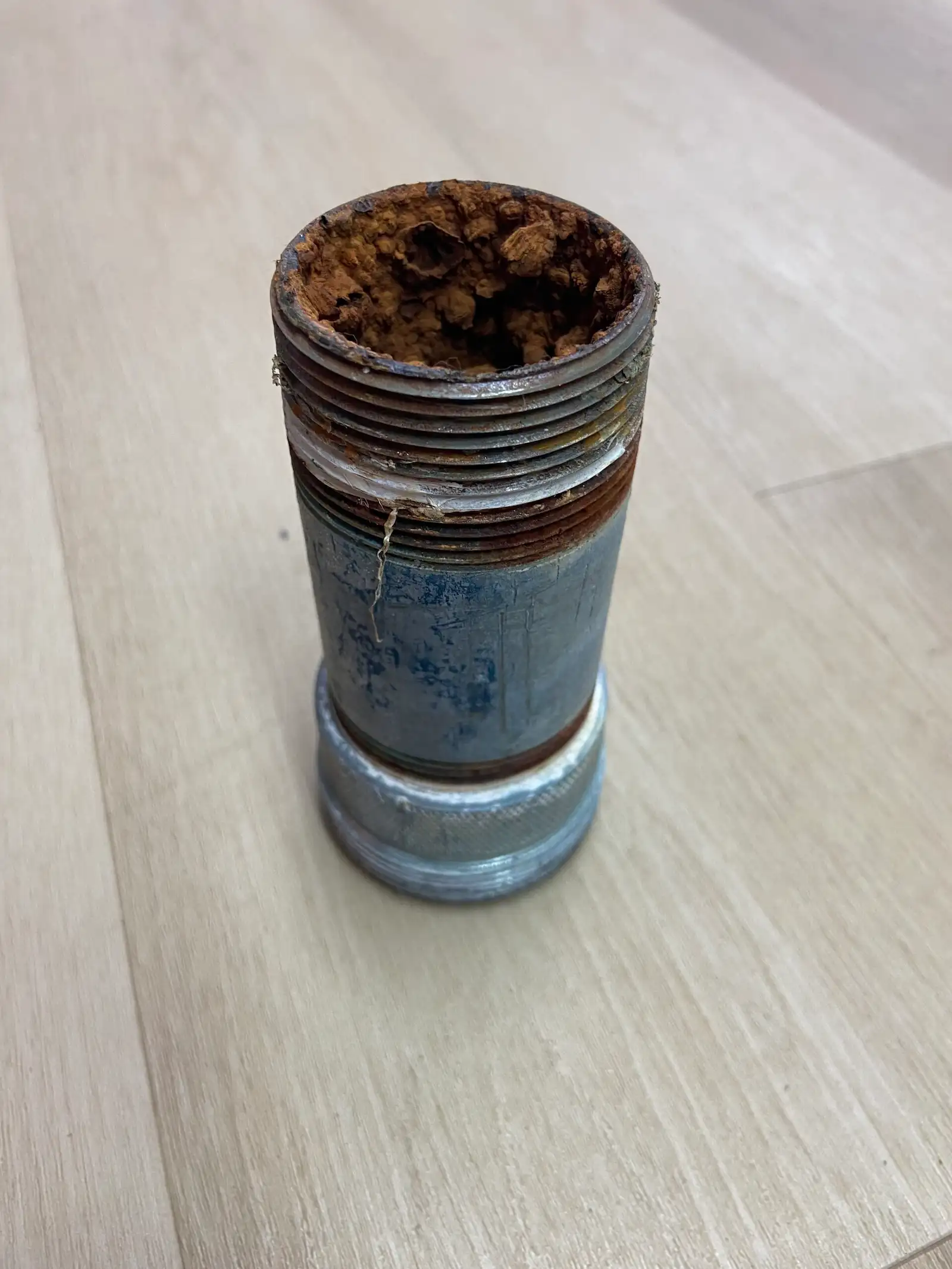 heavily-corroded-galvanized-steel-pipe-nipple-with-rust-blockage Galvanized steel pipe nipple with significant rust and sediment blockage, highlighting the need for re-piping in Tampa homes