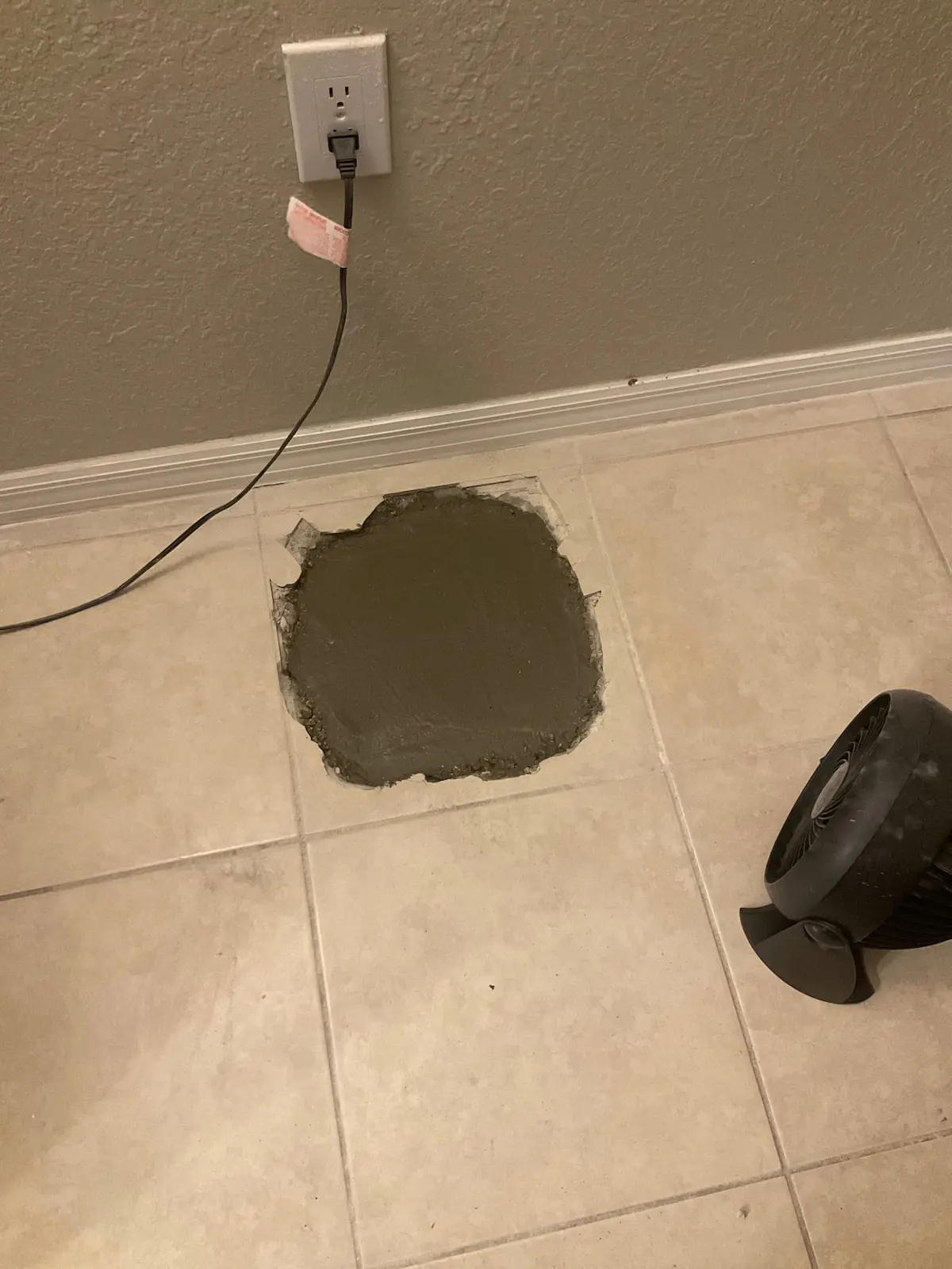 Tile floor repaired with fresh concrete after slab pipe repair by a Hillsborough County plumber.