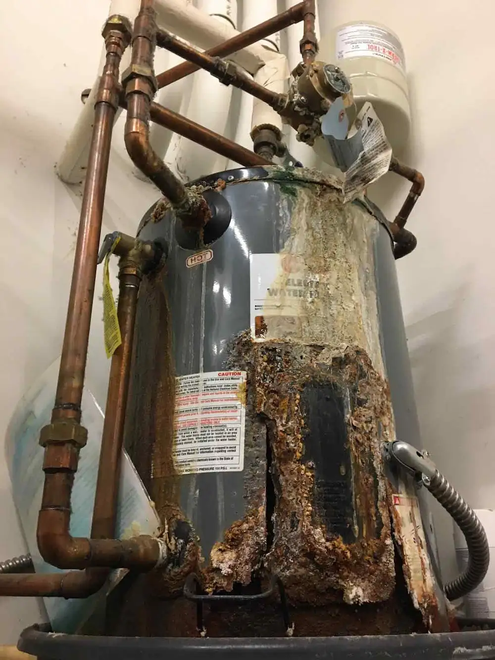 Severely corroded water heater needing replacement by a Hillsborough County plumber.