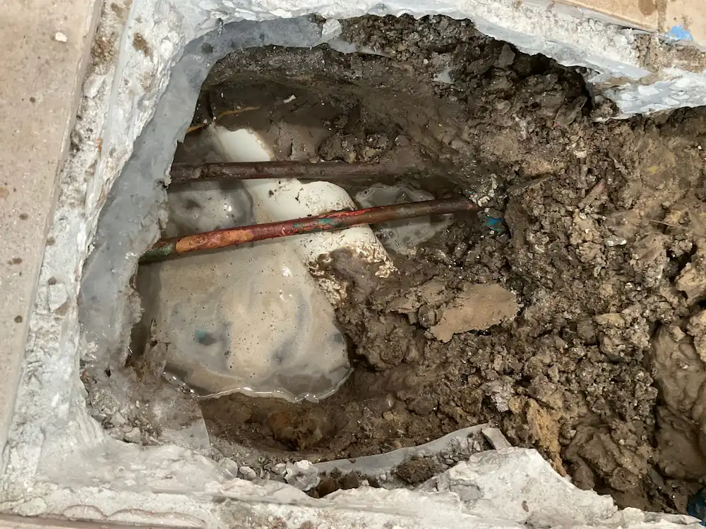 Exposed water pipes under a home’s slab during leak repair by a Hillsborough County plumber.