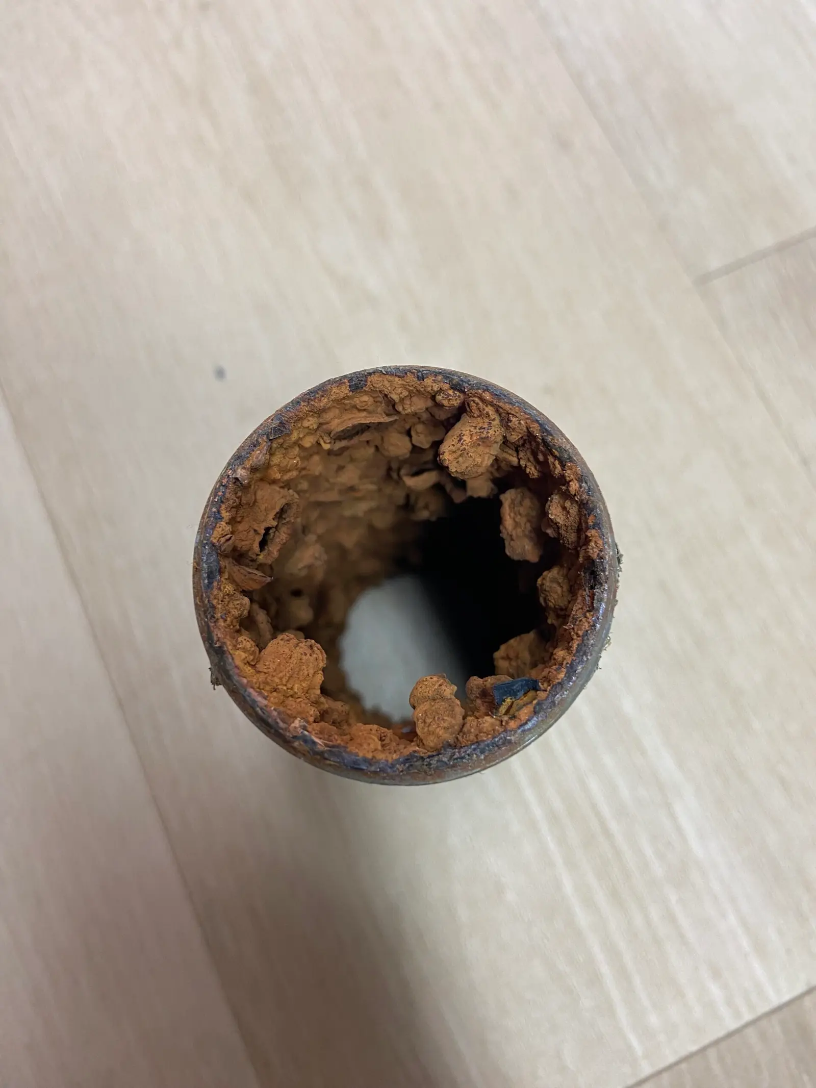 rusted-galvanized-pipe-with-severe-internal-corrosion-and-flow-restriction Cutaway view of a galvanized pipe showing heavy internal corrosion restricting water flow in an aging Tampa plumbing system