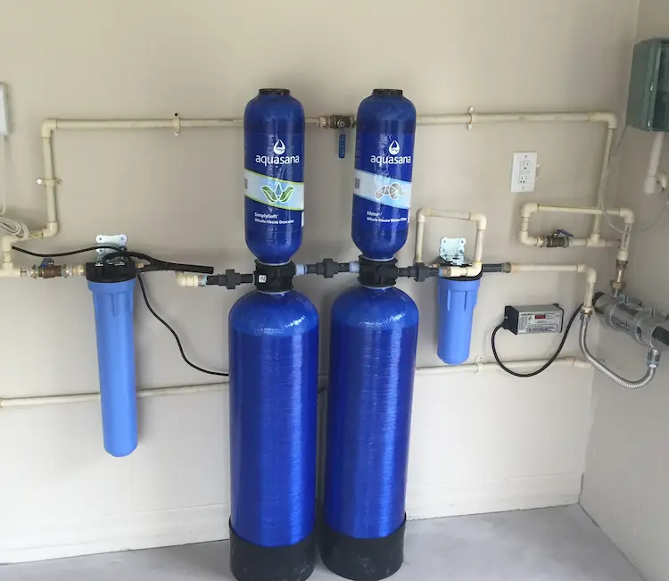 Aquasana whole-house water filtration and softener system with sediment prefilter and carbon tanks installed in an Avila, Tampa home.