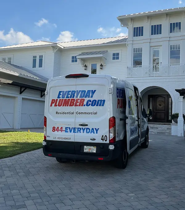EVERYDAYPLUMBER.com service van in the driveway of a Tampa home for 24/7 emergency plumbing