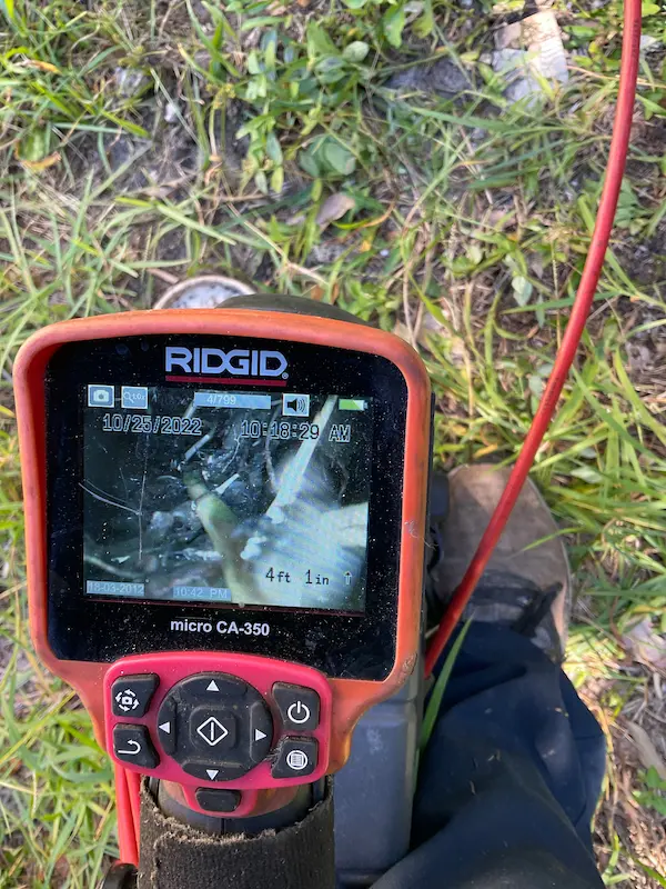 Sewer video camera inspection monitor showing inside of drain line to locate blockages, leaks, or damaged pipes