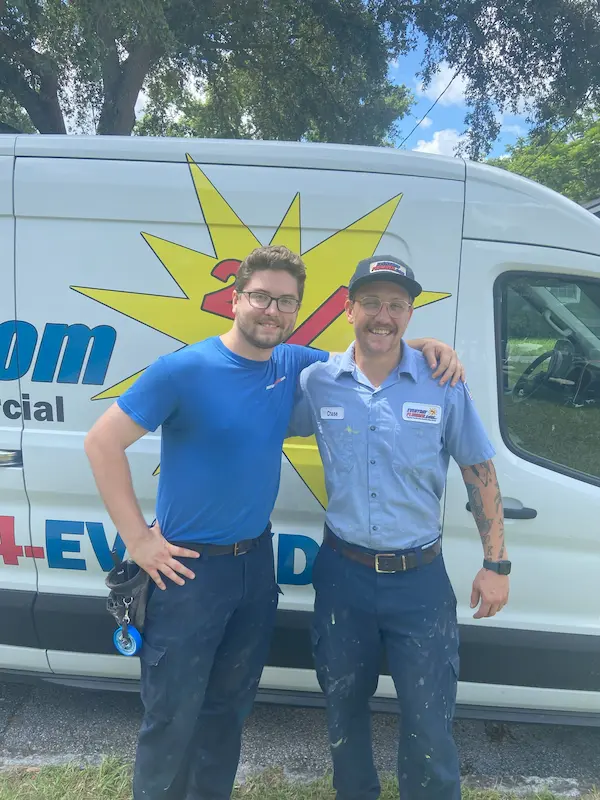 Two EVERYDAYPLUMBER.com technicians in uniform standing beside a branded service van, friendly team ready for same-day plumbing service in Hillsborough County.