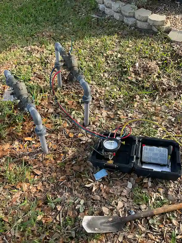 Backflow preventer testing and repair using gauge kit on irrigation assembly in St. Petersburg by EVERYDAYPLUMBER.com