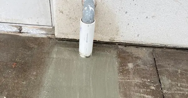 Sewer and drain line repair with concrete patch around exterior PVC pipe by St. Petersburg plumbers at EVERYDAYPLUMBER.com