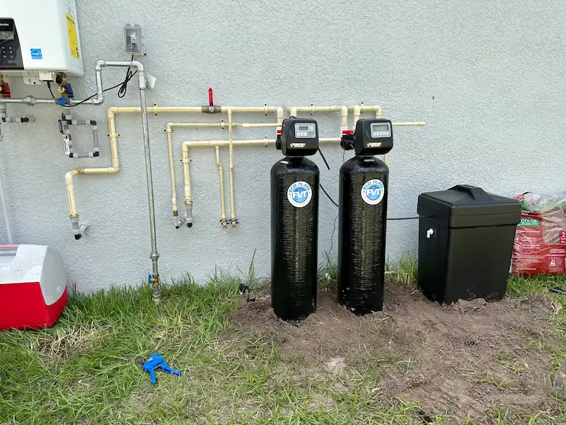 water-filtration-system-installation-tampa Professional water filtration system installation by a Tampa plumber, featuring dual tanks and a water softener unit.