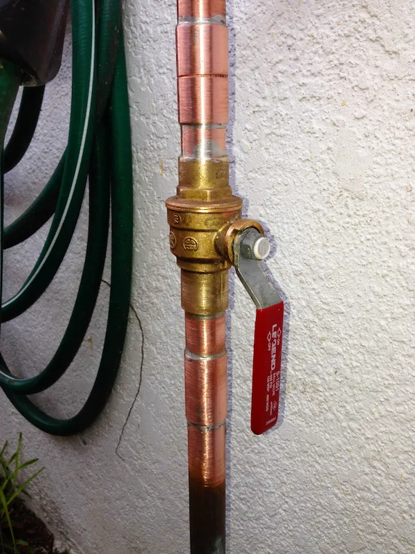 Repaired copper water line with new brass ball shutoff valve