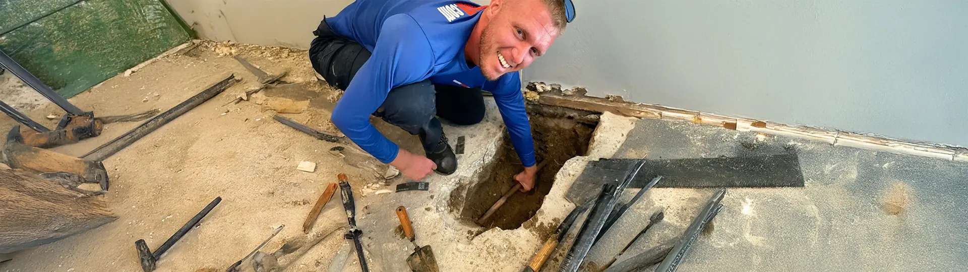 EVERYDAYPLUMBER.com technician repairing slab leak under concrete floor in Tampa home