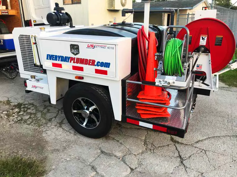 Hydro jetting trailer with high-pressure hoses for commercial drain cleaning