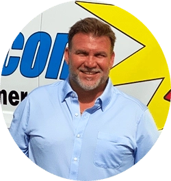 Mike Haisten, owner and master plumber at EVERYDAYPLUMBER.com, smiling in a light blue shirt in front of the company service van