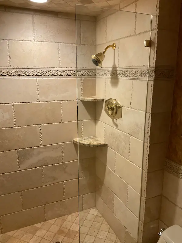 Tiled shower with new brass showerhead and valve installed, bathroom plumbing in Ybor City