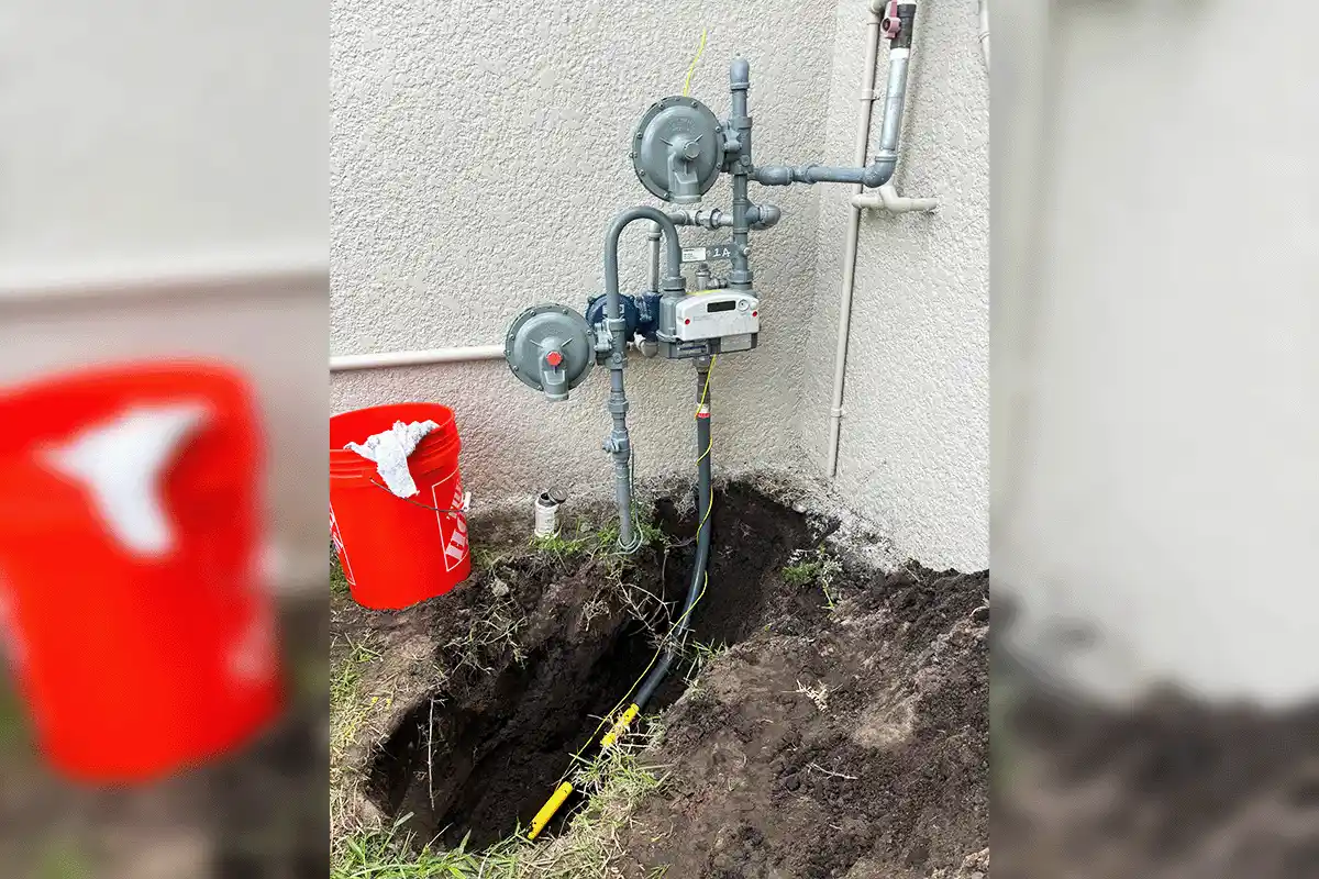 Excavated commercial gas line with meter and pressure regulator installation completed by EverydayPlumber.com on a Tampa Bay commercial property