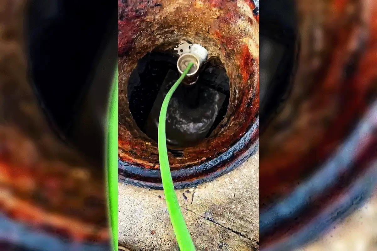 EverydayPlumber.com hydro jetting hose inserted into a heavily corroded commercial drain pipe in Tampa Bay