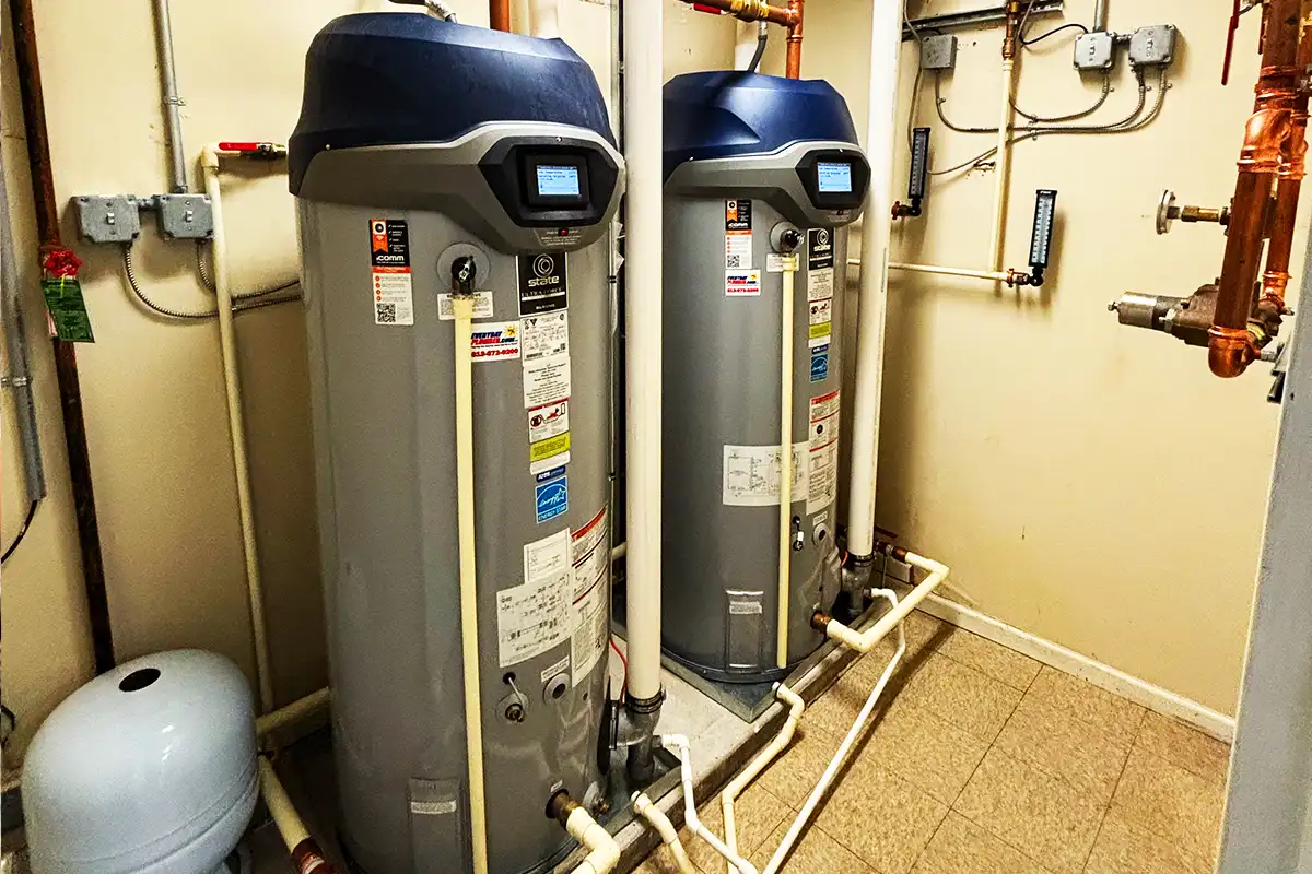 Two large commercial water heaters installed by EverydayPlumber.com in a Tampa Bay commercial utility room with copper supply lines