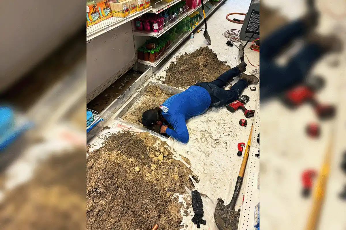 EverydayPlumber.com plumber performing under-slab commercial plumbing repair excavated through a retail store floor in Tampa Bay