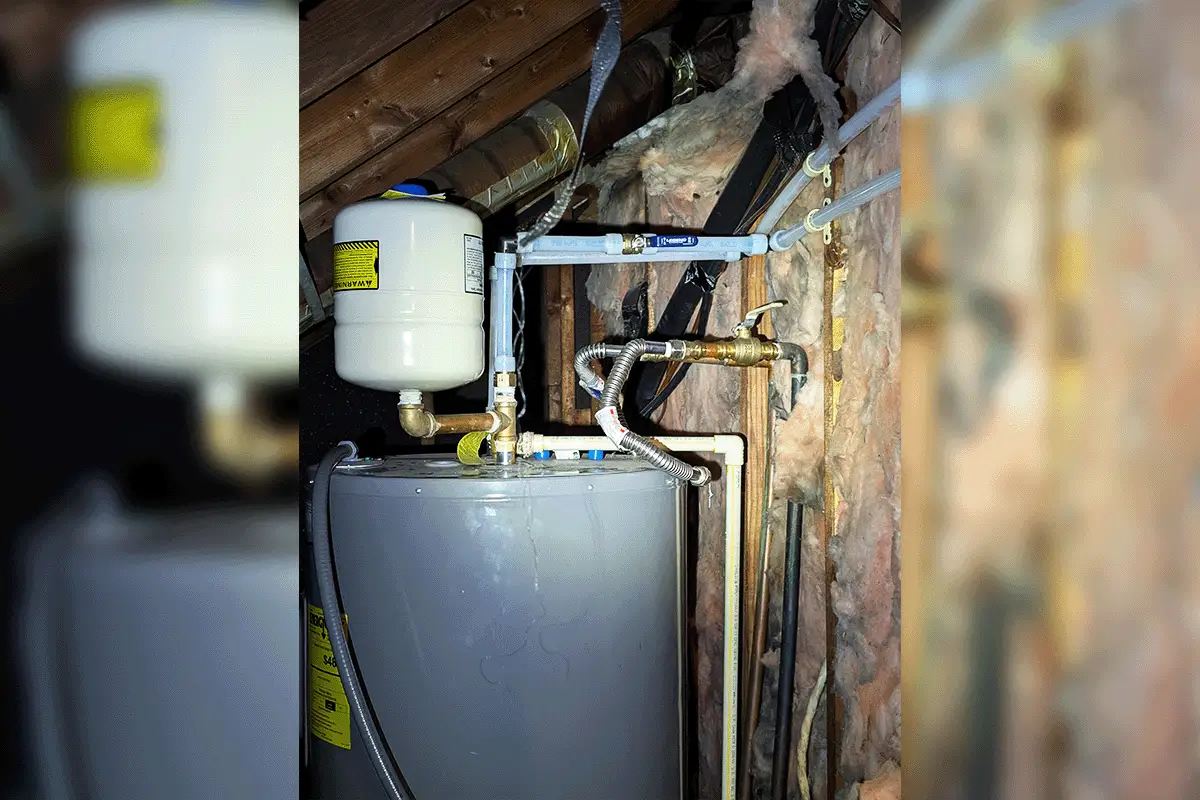 New PEX supply lines connected to a residential water heater and expansion tank in an attic during a whole house repipe by EverydayPlumber.com in Tampa Bay