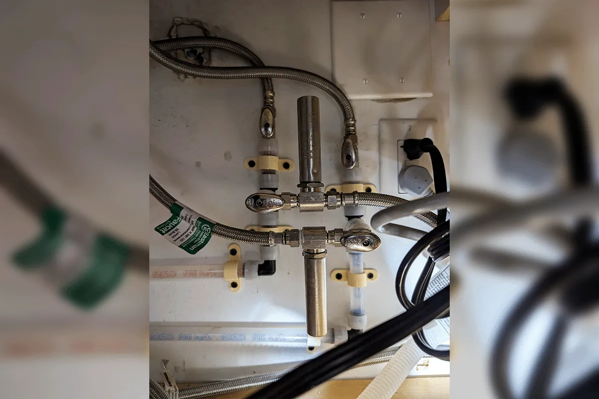 New PEX fixture supply connections and braided stainless lines installed under a sink during a whole house repipe by EverydayPlumber.com in Tampa Bay