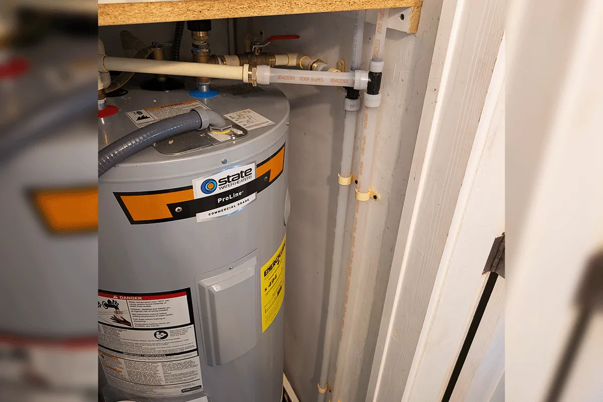 New Uponor PEX-A supply lines connected to a residential water heater with shutoff valves during a whole house repipe by EverydayPlumber.com in Tampa Bay