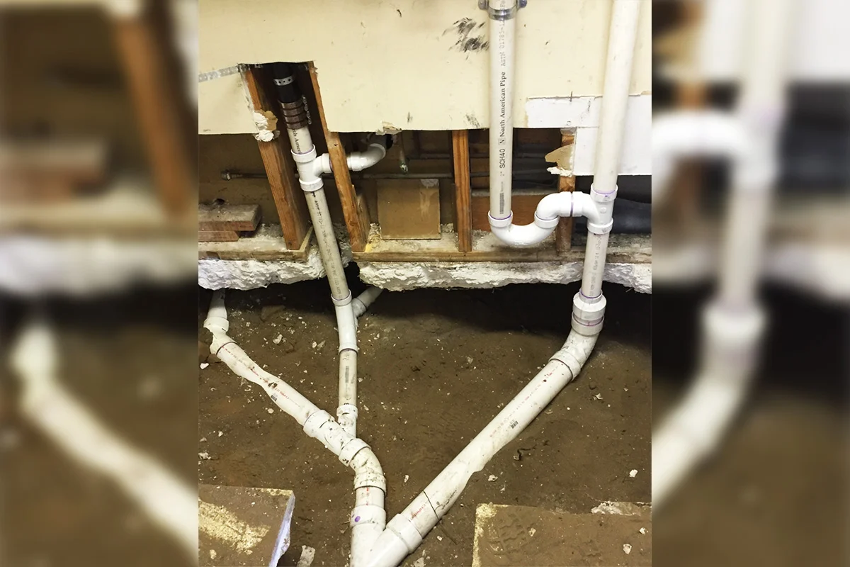 New Schedule 40 PVC drain lines installed beneath a Tampa Bay home during a sewer line replacement by EverydayPlumber.com showing properly fitted connections and cleanout access